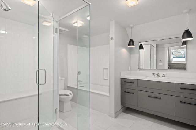 bathroom featuring tile patterned floors, a shower with door, a skylight, vanity, and toilet