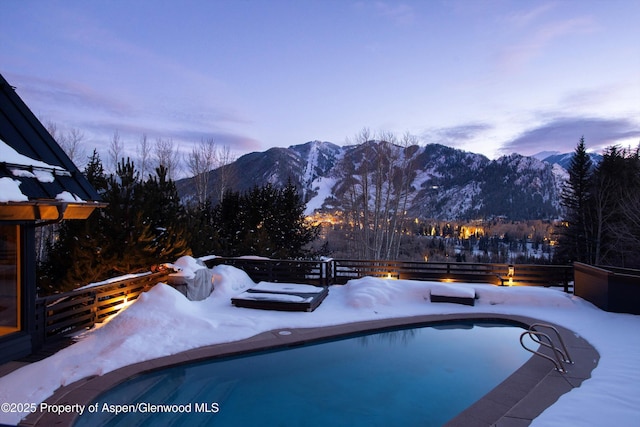 snow covered pool featuring a mountain view