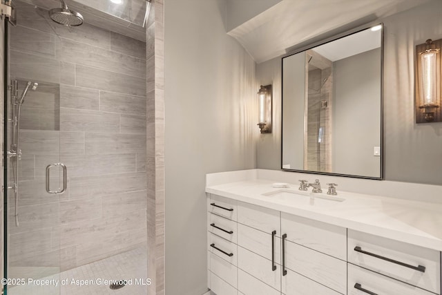 bathroom featuring walk in shower and vanity