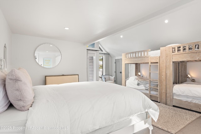 carpeted bedroom featuring lofted ceiling with beams