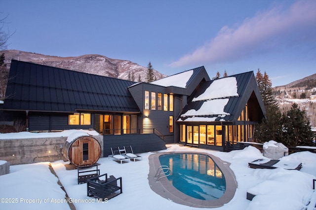 snow covered property featuring a mountain view