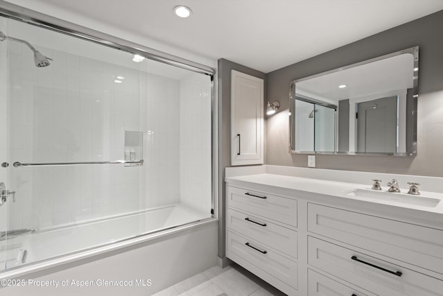 bathroom with vanity, tile patterned flooring, and enclosed tub / shower combo