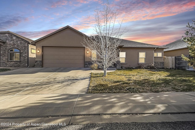 view of front of property featuring stone siding and stucco siding