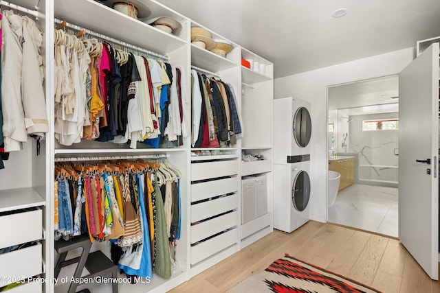 373 Sopris Creek Rd Unit 6, Basalt, CO 81621 - washroom with stacked washer / dryer and light wood-style floors