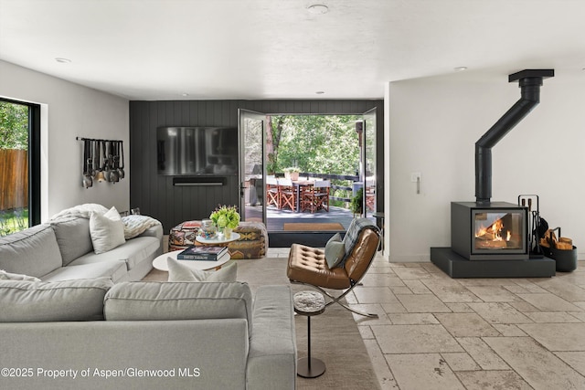 373 Sopris Creek Rd Unit 6, Basalt, CO 81621 - living area featuring stone tile floors and a wood stove