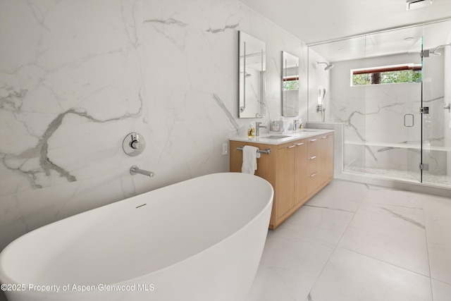 373 Sopris Creek Rd Unit 6, Basalt, CO 81621 - full bath featuring marble look tiles, double vanity, a freestanding bath, and a marble finish shower
