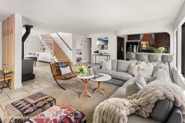 373 Sopris Creek Rd Unit 6, Basalt, CO 81621 - living room featuring stairway, stone tile flooring, and a wood stove