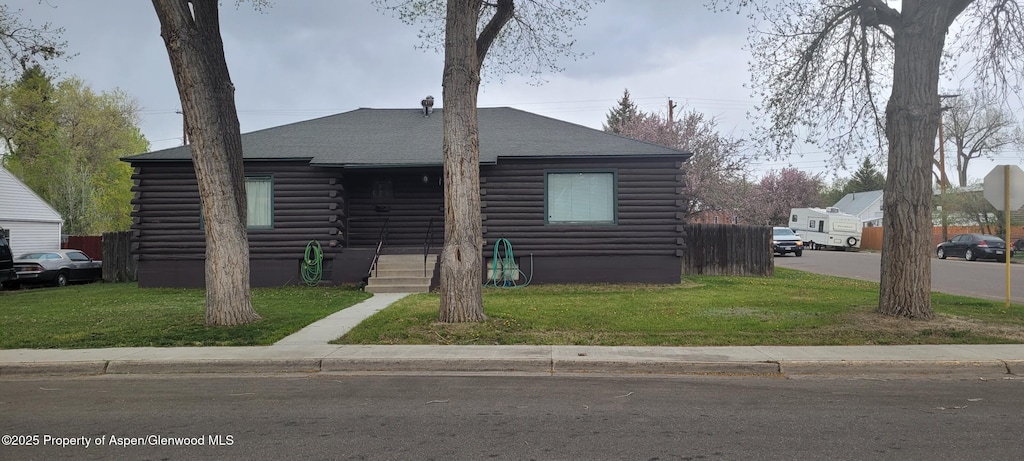 586 Tucker St, Craig, CO 81625 - log-style house with log siding, a front yard, and roof with shingles