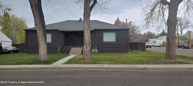 586 Tucker St, Craig, CO 81625 - log-style house with log siding, a front yard, and roof with shingles