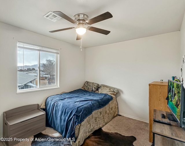 bedroom with ceiling fan, carpet flooring, visible vents, and baseboards