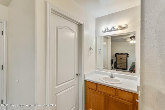 bathroom with ceiling fan and vanity