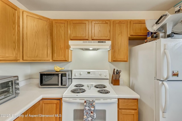 kitchen with under cabinet range hood, a toaster, white appliances, and light countertops