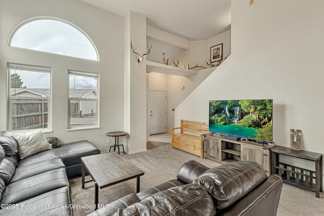 carpeted living room featuring baseboards