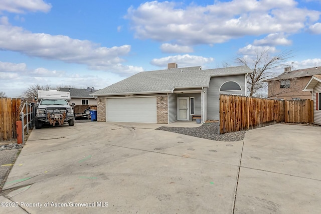 ranch-style home with a garage, driveway, roof with shingles, fence, and brick siding