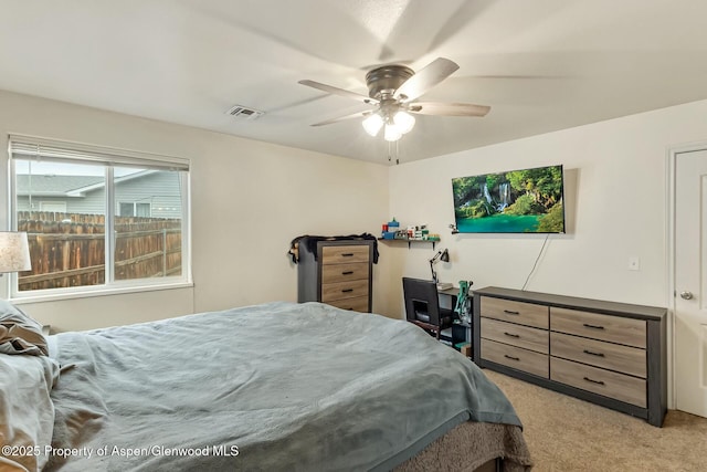 bedroom with light carpet, ceiling fan, and visible vents