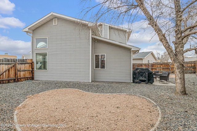 back of house with a patio area and a fenced backyard