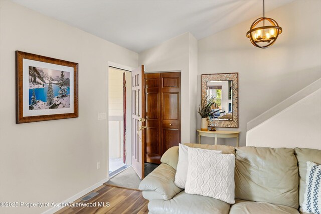 4122 Sky Ranch Dr, Glenwood Springs, CO 81601 - foyer entrance with wood finished floors, a chandelier, vaulted ceiling, and baseboards