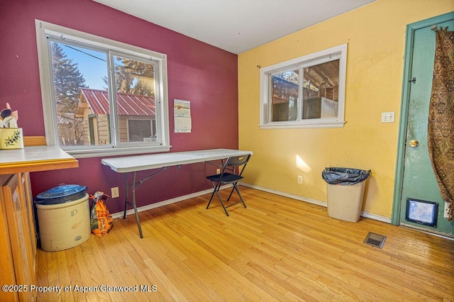 misc room featuring wood finished floors, visible vents, and baseboards