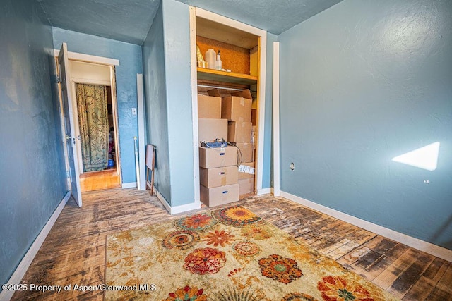 unfurnished bedroom with baseboards and wood finished floors