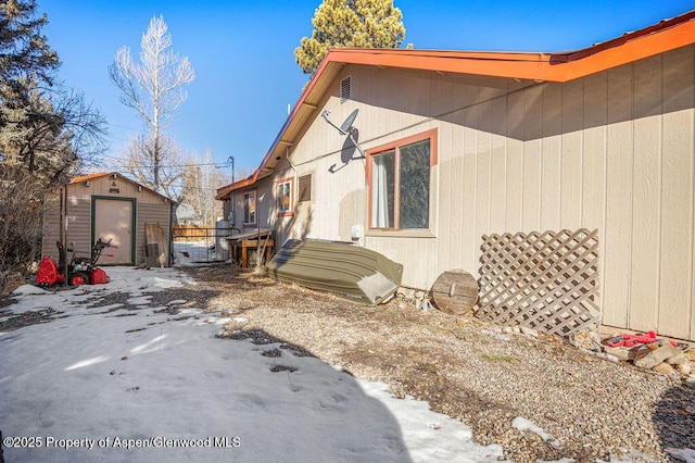 view of side of property with an outbuilding and a shed