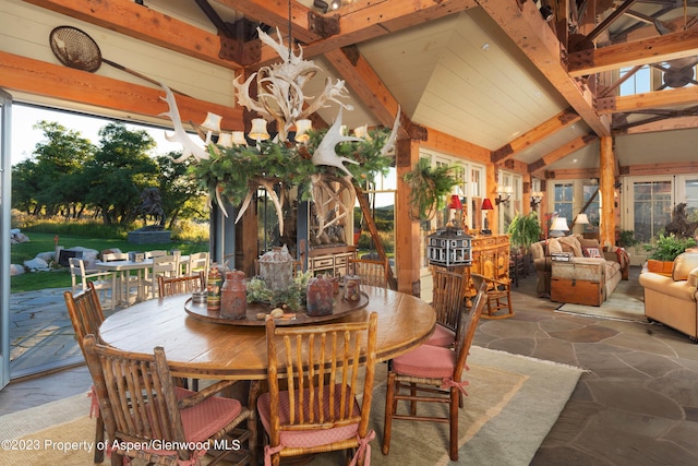 dining room with vaulted ceiling with beams