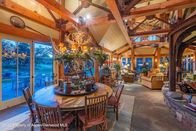 dining room with beam ceiling, high vaulted ceiling, and a notable chandelier