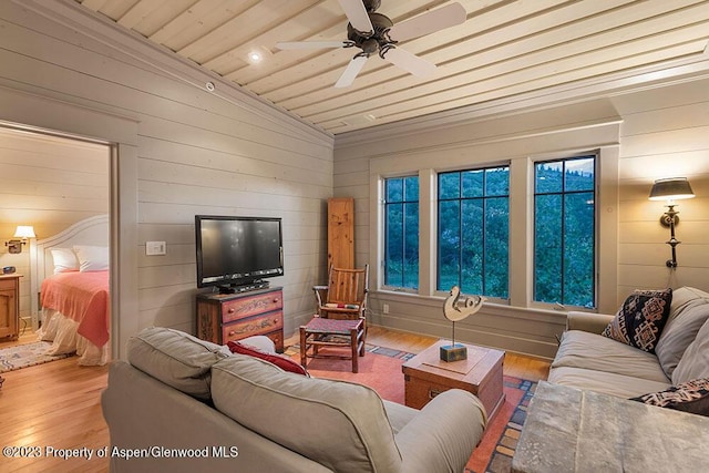 living room featuring ceiling fan, wood-type flooring, vaulted ceiling, wooden walls, and wood ceiling