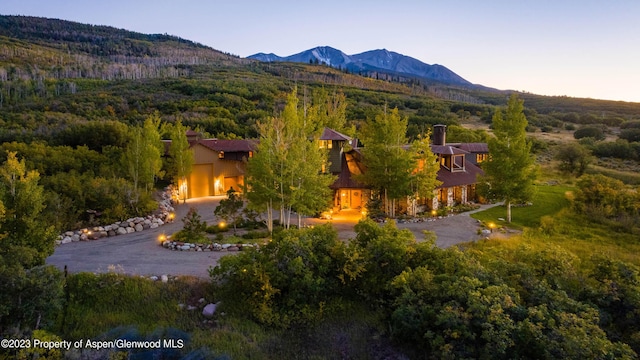 aerial view at dusk featuring a mountain view