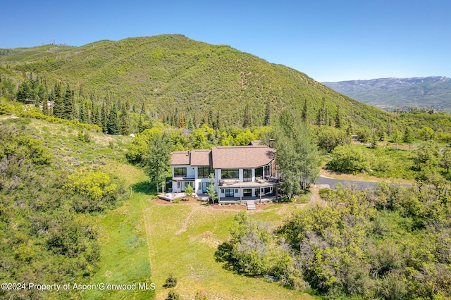 bird's eye view with a mountain view and a forest view