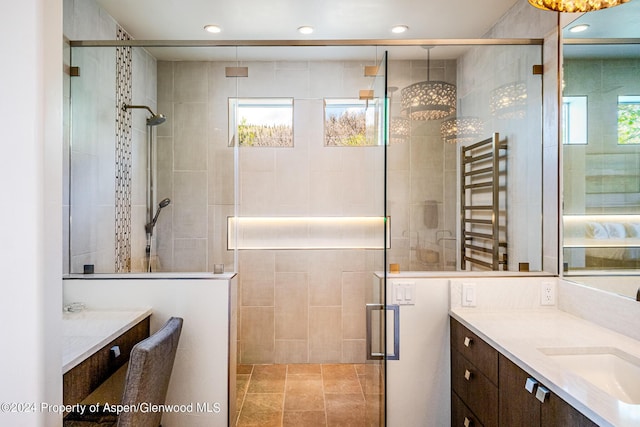 bathroom with recessed lighting, radiator, vanity, and a shower stall