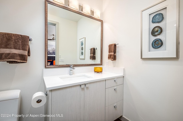 bathroom featuring toilet and vanity