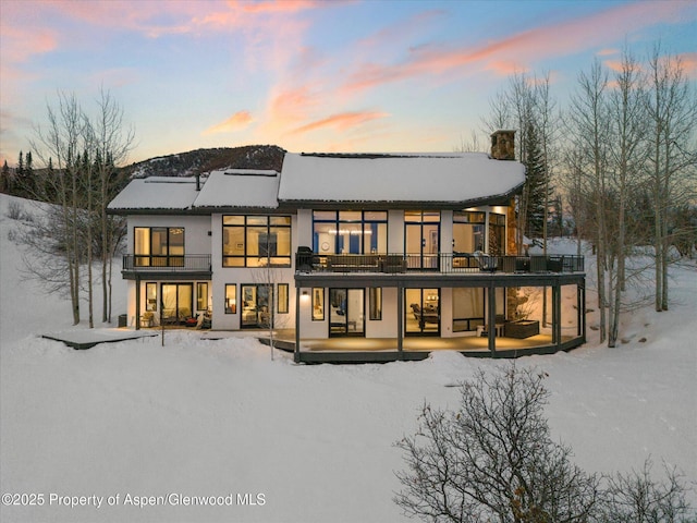 36125 Quarry Ridge Rd, Steamboat, CO 80487 - snow covered property featuring a balcony, stucco siding, a chimney, and a patio