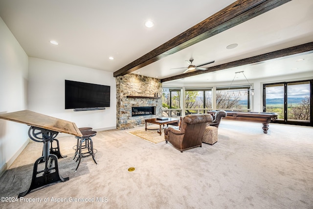 living area featuring billiards, a stone fireplace, carpet flooring, and beam ceiling