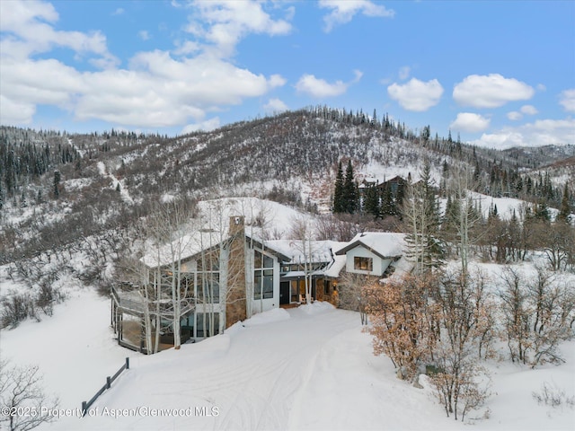 snowy aerial view featuring a mountain view