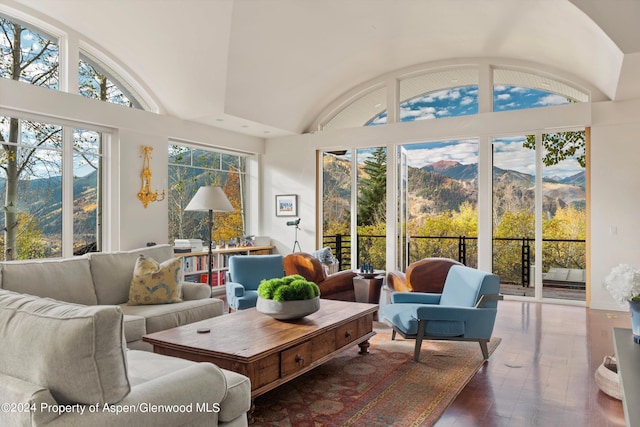 sunroom featuring a mountain view and vaulted ceiling