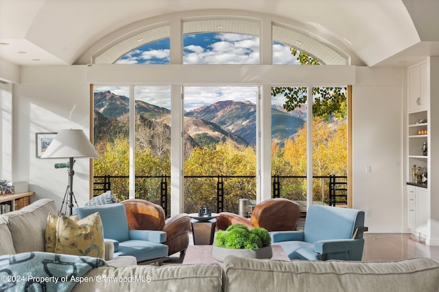 sunroom / solarium with a mountain view and lofted ceiling