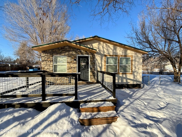 455 E 7th St, Craig, CO 81625 - view of front of property with stone siding and a deck