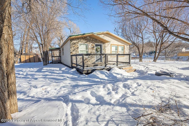 455 E 7th St, Craig, CO 81625 - view of front of property with stone siding and an outbuilding