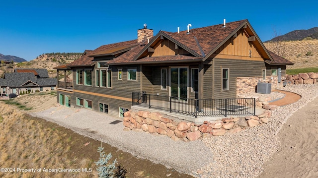 rear view of house featuring a mountain view and cooling unit