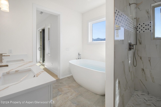 bathroom featuring shower with separate bathtub and vanity