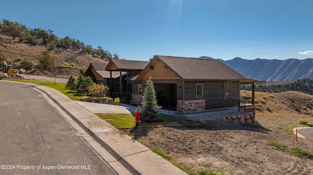 view of front of home with a mountain view and a garage