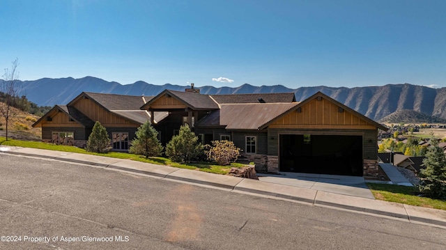 view of front of property featuring a mountain view and a garage