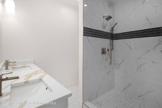 bathroom featuring vanity and tiled shower