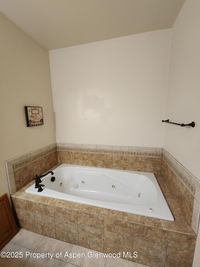 bathroom featuring tiled tub and tile patterned floors