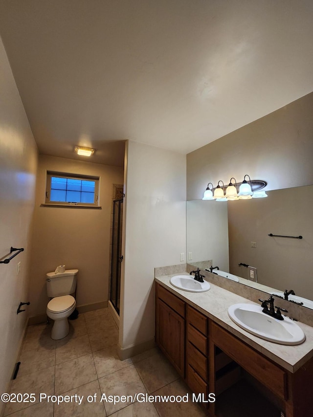 bathroom featuring an enclosed shower, vanity, toilet, and tile patterned flooring