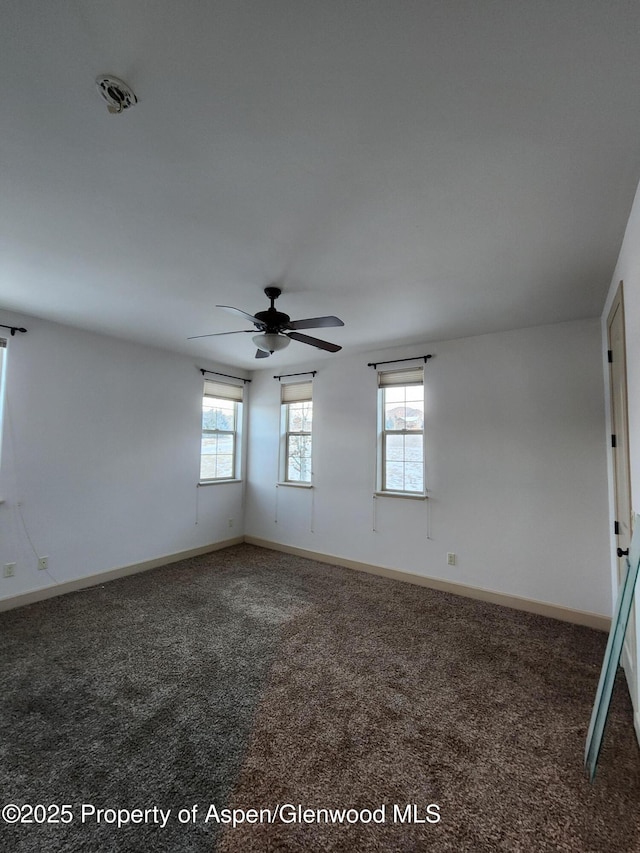 carpeted spare room with ceiling fan