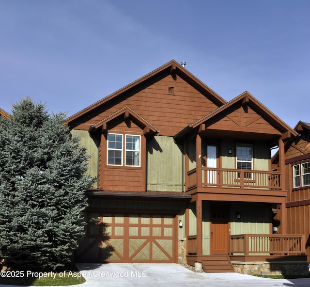 279 Whitehorse Dr, New Castle, CO 81647 - view of front of property featuring driveway, a balcony, board and batten siding, and an attached garage