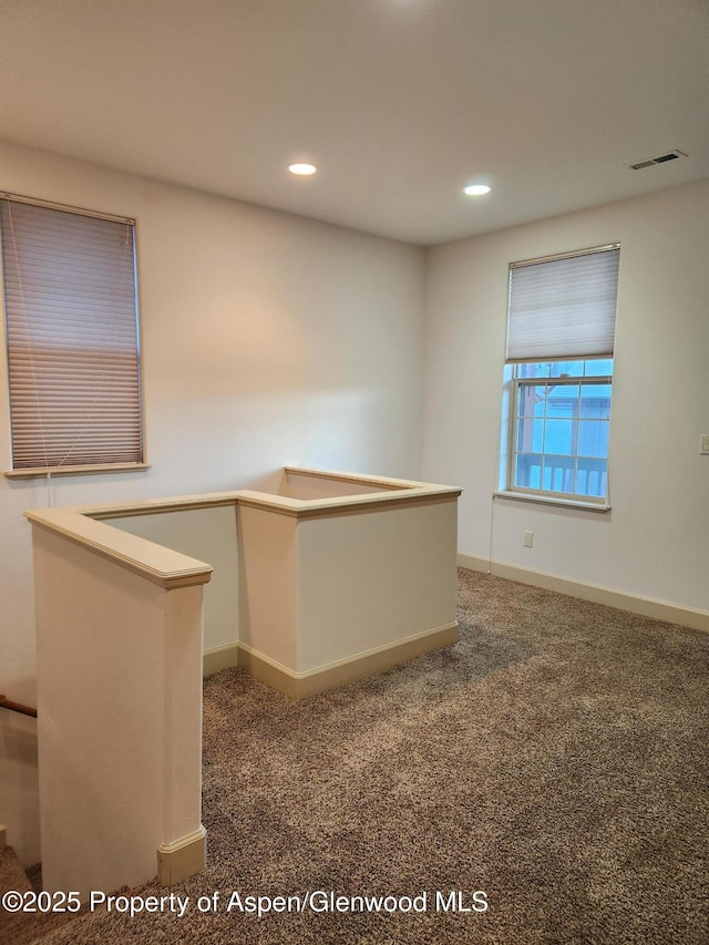 interior space featuring dark colored carpet