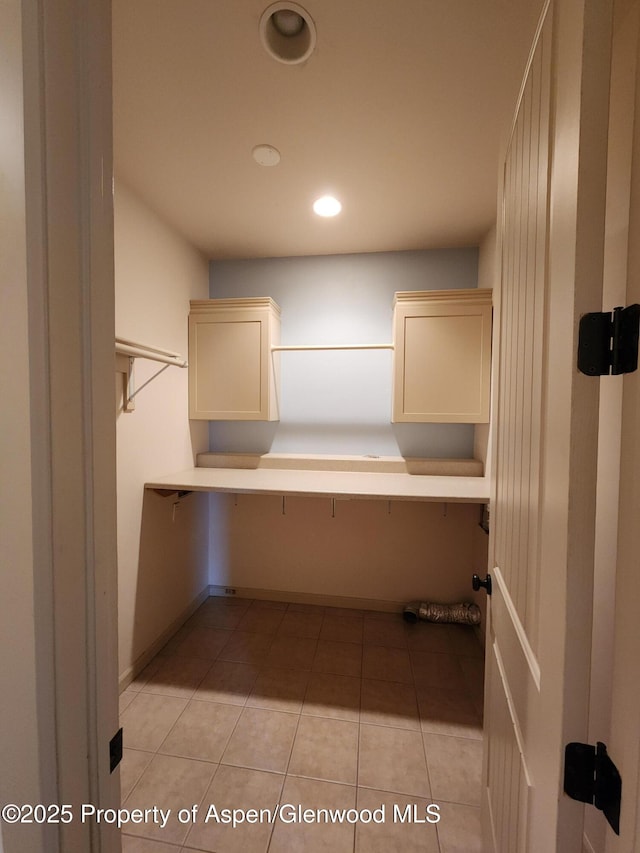 clothes washing area featuring light tile patterned flooring