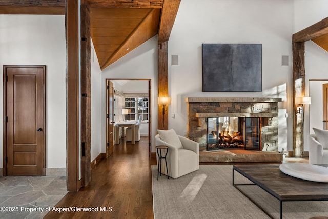 living room featuring a fireplace, hardwood / wood-style floors, lofted ceiling, and wood ceiling